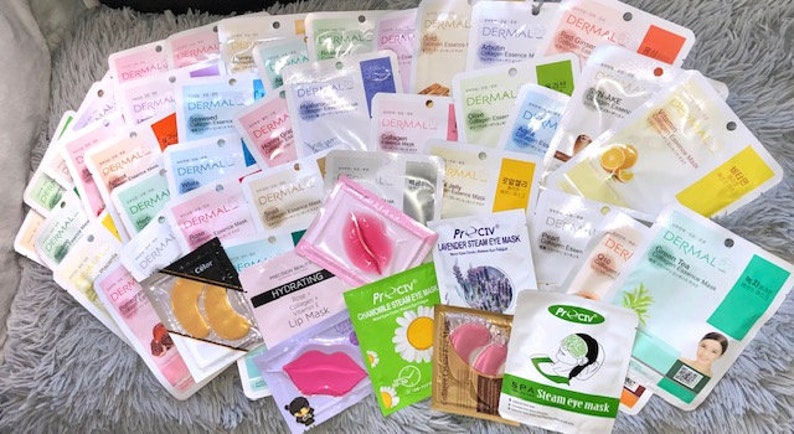 May include: A selection of face masks and eye patches in a variety of colours and designs. The masks feature different ingredients, including green tea, collagen, and lavender. The eye patches are gold, pink, and white.