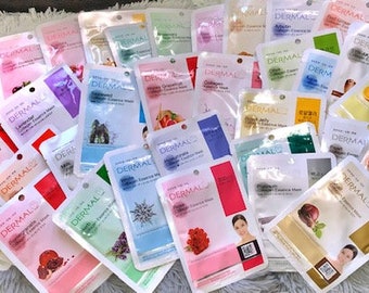 May include: A selection of face masks in individual sachets, featuring various ingredients and benefits. The sachets are white with blue and green accents, and the text 'Dermal' is printed on each sachet.