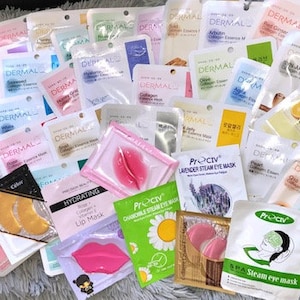 May include: An assortment of face masks and eye patches in various colours and designs. The masks feature different ingredients, including green tea, collagen, and lavender. The eye patches are gold, pink, and white.