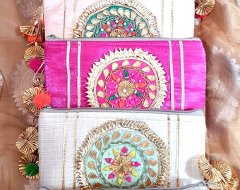 May include: Six colorful embroidered pouches with gold trim and tassels. Each pouch features a circular design with intricate details and a variety of colors.
