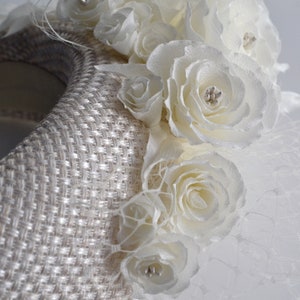 Bridal headpiece is hand stitched. With it's contemporary halo-design, wedding head piece for bride is the perfect hybrid design. The padded halo headband is finished with ivory fabric. Wedding hairpiece is adorned with flowers and leaves.