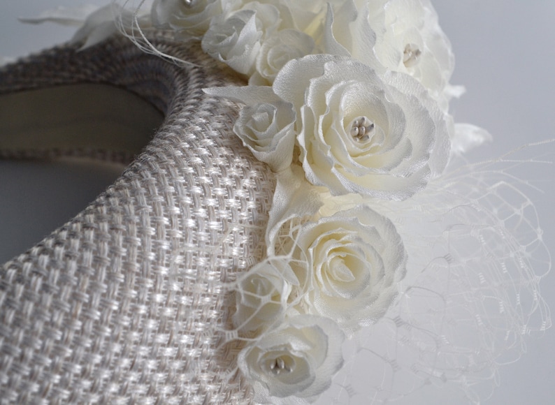 Bridal headpiece is hand stitched. With it's contemporary halo-design, wedding head piece for bride is the perfect hybrid design. The padded halo headband is finished with ivory fabric. Wedding hairpiece is adorned with flowers and leaves.