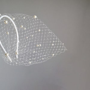 Wedding birdcage blusher veil features and multi-sized pearls. Bridal hairband with bandeau veil is hand made. Bachelorette veil come with pearls or without. 
Ivory headband covered with bird cage veil giving the bridal shower veil a superior finish.
