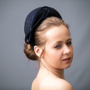 Navy blue fascinator headband for wedding guest is hand made. Navy halo headband crown comes with velvet double bow or without.
Wedding guest hairband covered in sequins tweed. Wedding fascinator trimmed with intone asymmetrical double bow.
