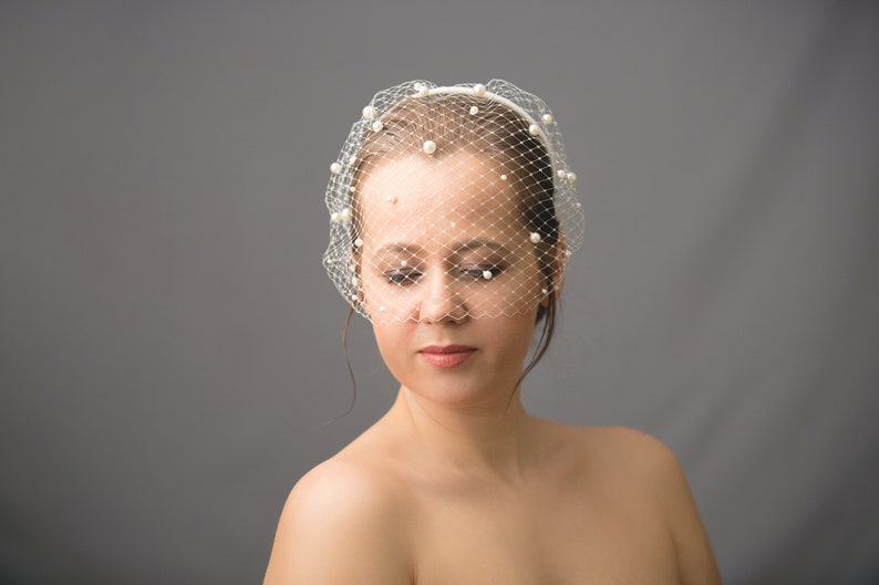 Wedding birdcage blusher veil features and multi-sized pearls. Bridal hairband with bandeau veil is hand made. Bachelorette veil come with pearls or without. 
Ivory headband covered with bird cage veil giving the bridal shower veil a superior finish.