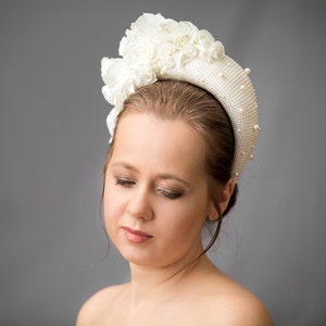 Bridal headpiece is hand stitched. With it's contemporary halo-design, wedding head piece for bride is the perfect hybrid design. The padded halo headband is finished with ivory fabric. Wedding hairpiece is adorned with flowers and leaves.