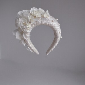 Bridal headband with pearls inspired by Kate Middleton.  Bridal flower crown  comes with faux pearls. 
Bridal hairband has been trimmed with flowers Wedding fascinator will instantly elevate any outfit.
This silk flower crown is unique work.