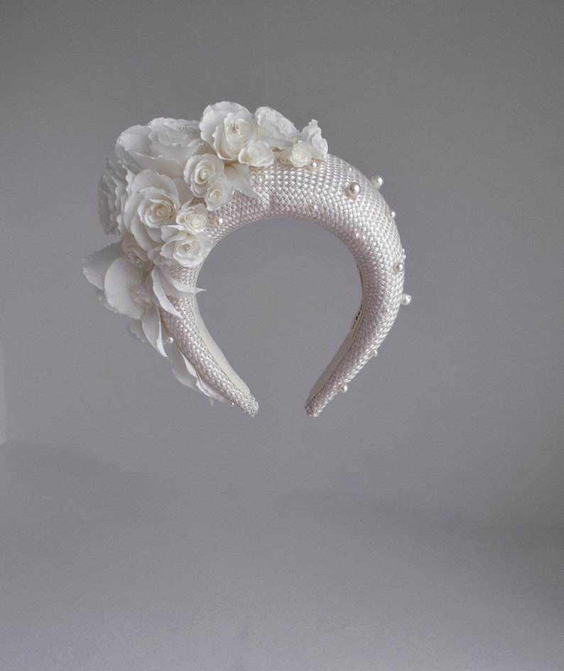 Bridal headband with pearls inspired by Kate Middleton.  Bridal flower crown  comes with faux pearls. 
Bridal hairband has been trimmed with flowers Wedding fascinator will instantly elevate any outfit.
This silk flower crown is unique work.