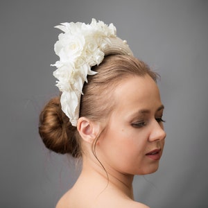 Bridal headband with pearls is hand made. Bidal flower crown comes with multi-sized faux pearls. Bridal hairband has been covered in ivory fabric. Halo crown headband has been trimmed with flowers. Wedding fascinator will instantly elevate any outfit