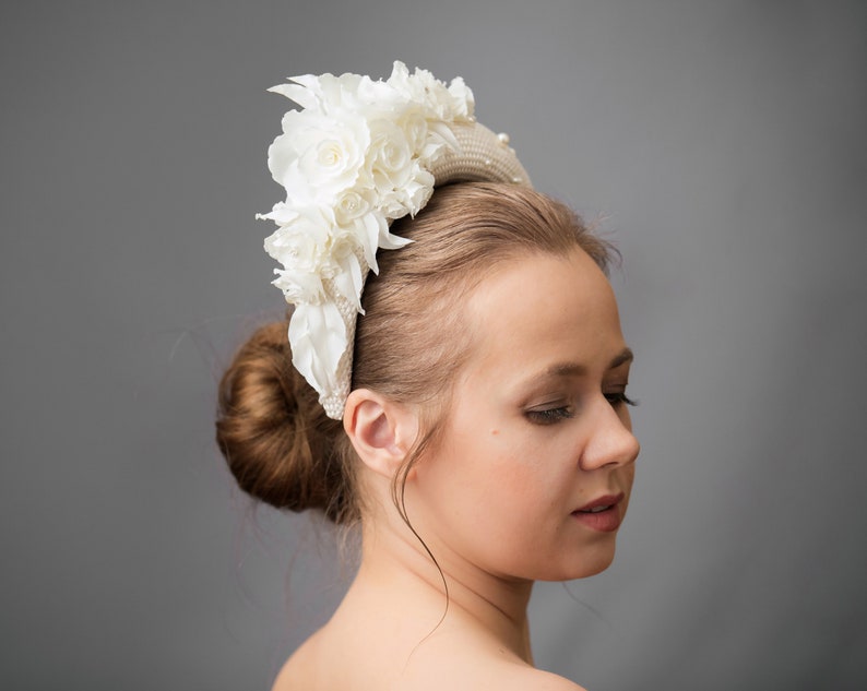 Bridal headband with pearls is hand made. Bidal flower crown comes with multi-sized faux pearls. Bridal hairband has been covered in ivory fabric. Halo crown headband has been trimmed with flowers. Wedding fascinator will instantly elevate any outfit