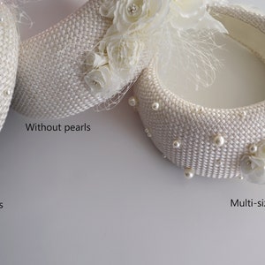 This bridal flower crown features a floral headpiece. Cream wedding fascinator headband with birdcage veil inspired by Kate Middleton headband hat. Perfect as alternative to a traditional bridal hairband. Padded headband is finished with ivory fabric