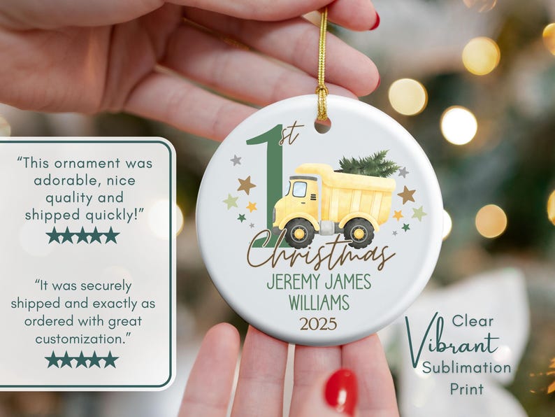 May include: Round Christmas ornament with a yellow dump truck, green accents, and the text "1st Christmas" and a name. The ornament has a gold string for hanging. The design is a clear, vibrant sublimation print.