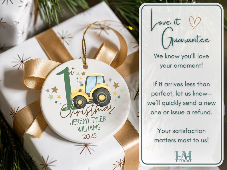 May include: A round Christmas ornament with a yellow tractor illustration, the text "1st Christmas", and the name "Jeremy Tyler Williams" with the year 2025. The ornament is on a wrapped gift with a gold ribbon.
