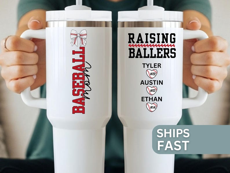 May include: White insulated tumbler with a handle, featuring the text "BASEBALL mom" in red and black. The other side says "RAISING BALLERS" with names and baseball heart graphics. A great gift for baseball fans.