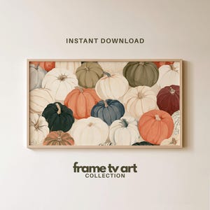 May include: A rectangular digital art print in a light wood frame featuring a pattern of pumpkins in shades of orange, white, green, blue, and dark red. The text INSTANT DOWNLOAD appears above the frame, and frame tv art COLLECTION is below.