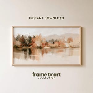 May include: A rectangular landscape painting in a light wood frame featuring a serene lake scene with autumn-toned trees in shades of orange, brown, and muted green. The text INSTANT DOWNLOAD and frame tv art COLLECTION appear above and below.