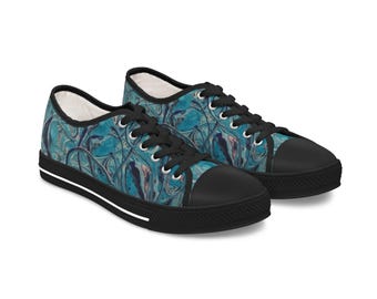 Può includere: Un paio di scarpe da ginnastica basse in tela nera con un motivo astratto blu e bianco. Le scarpe hanno lacci bianchi e una striscia bianca intorno alla suola.