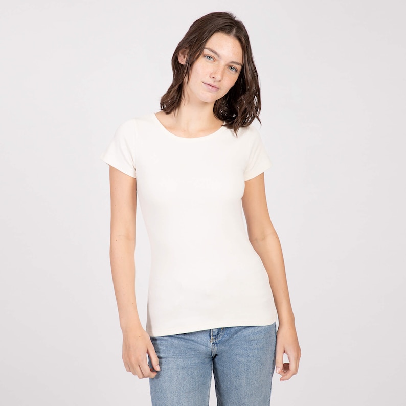 May include: A white short-sleeved t-shirt with a round neckline.