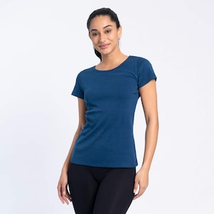 May include: A woman wearing a dark blue short-sleeved t-shirt and black trousers.