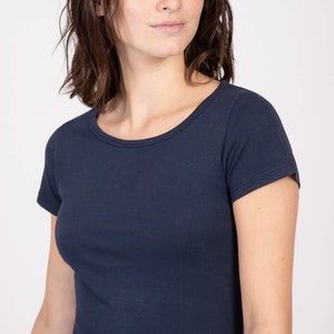 May include: A navy blue short-sleeved t-shirt with a round neckline.