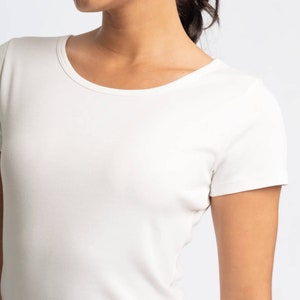 May include: A white short-sleeved t-shirt with a round neckline.