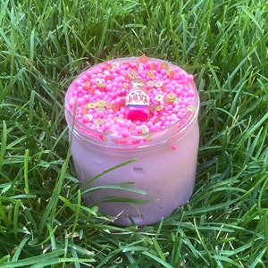 May include: A pink slime with gold and pink beads in a clear jar. The slime has a small bottle with the word "LOVE" on it.