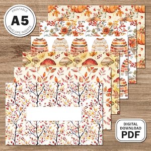 May include: Printable A5 envelope inserts with autumn-themed designs. The inserts feature watercolor illustrations of pumpkins, leaves, sweaters, mushrooms, and branches with berries. The inserts are labeled "Printable A5 Envelope Inserts" and "Digital Download PDF".