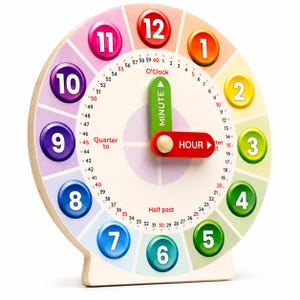 May include: A round wooden educational clock toy featuring colorful numbered buttons from 1 to 12 arranged in a circle. The clock face includes minute markers from 0 to 60, with text labels for O'Clock, Quarter to, and Half past. It has two movable hands.