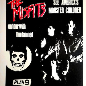 May include: Black and white concert poster for The Misfits, featuring a skull graphic and the text "SEE AMERICA'S MONSTER CHILDREN." The poster also includes the text "on tour with the damned" and "PLAN 9."