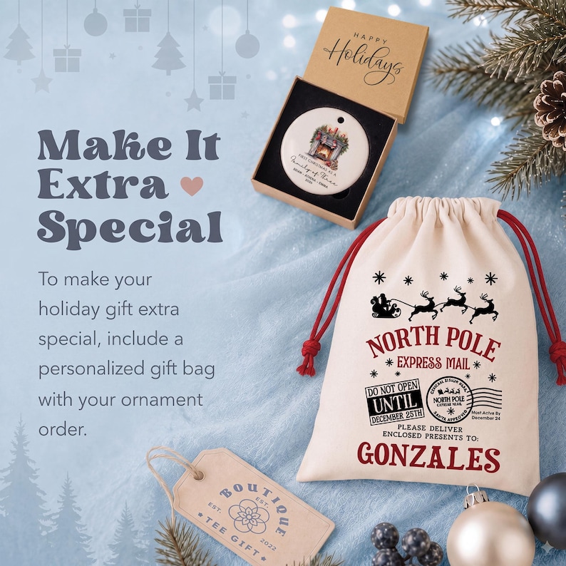 May include: A round white ceramic ornament inside a brown cardboard box labeled Happy Holidays, and a cream-colored drawstring gift bag with red cords. The bag features black and red text reading North Pole Express Mail and Gonzales.