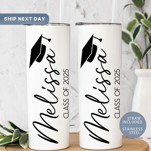 May include: Two white stainless steel tumblers with black text and a graduation cap design. The text on the tumblers reads "Melissa Class of 2025".