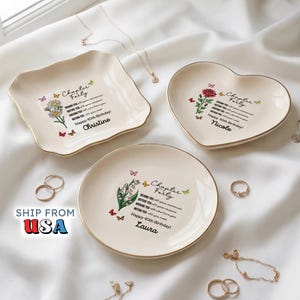 May include: Three cream-colored ceramic trinket dishes with gold-trimmed edges. Each dish features floral illustrations, colorful butterflies, and the text "Chapter Forty" with personalized names Christine, Nicole, and Laura, plus birthday wishes.