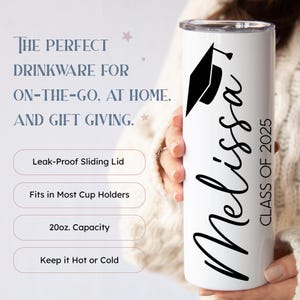 May include: White tumbler with a black graduation cap and the name "Melissa" and "Class of 2025" in black script. The tumbler has a leak-proof sliding lid, fits in most cup holders, and has a 20 ounce capacity.