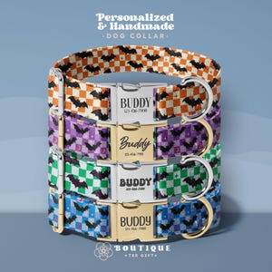 May include: Four stacked dog collars featuring a checkered pattern with bat silhouettes in orange, purple, green, and blue. Each collar has a metal buckle engraved with the name Buddy and a phone number, along with a metal D-ring for leash attachment.