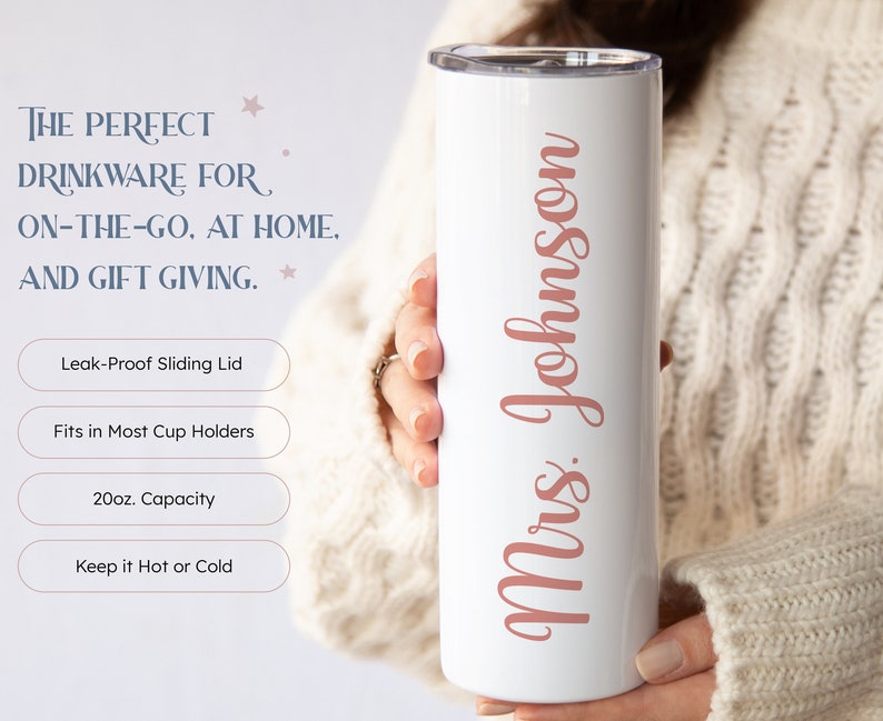 May include: White stainless steel tumbler with a pink inscription that reads "Mrs. Johnson". The tumbler has a sliding lid and is 20 fluid ounces in capacity.
