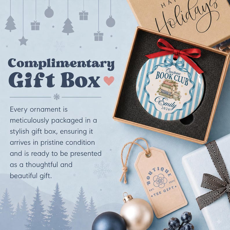 May include: A round ceramic ornament with blue and white vertical stripes, featuring a stack of books, a teacup, and the text "Custom Book Club" and "Emily 2026". It is topped with a red ribbon and presented in a square cardboard gift box.