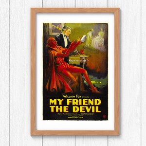 May include: Framed vintage movie poster for "My Friend the Devil." The artwork depicts a red devil reading a book, with a man in a suit and a woman in a white dress in the background. The poster includes the text "Read her diary!" and the movie title.