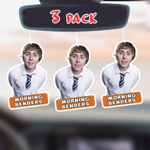 May include: Three air fresheners featuring a smiling person in a white shirt and striped tie. Each air freshener has the text "MORNING BENDERS" on an orange background. A car mirror displays the text "3 PACK".
