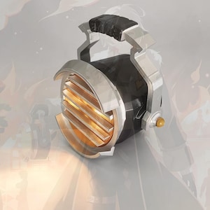 May include: A portable spotlight featuring a black cylindrical body with a silver metallic frame and handle. The front of the light has horizontal silver slats covering a glowing amber-coloured lens, with a small gold-toned knob on the side.