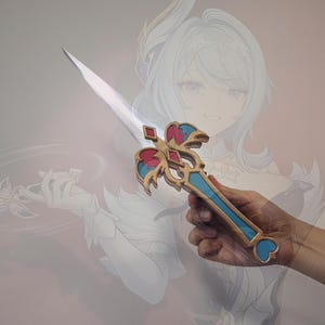May include: A decorative dagger featuring a silver-colored blade and an ornate handle with gold, blue, and magenta accents. The hilt displays a symmetrical design with a heart-shaped pommel, while the crossguard includes intricate wing-like details.
