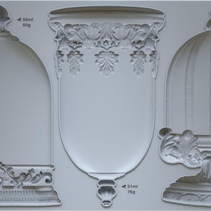 May include: A silicone mould for making three different cake toppers. The mould features a dome-shaped topper, a tall vase-shaped topper, and a smaller, round topper. Each topper has intricate details and a decorative base. The mould is labelled "Les Cloches 10D".