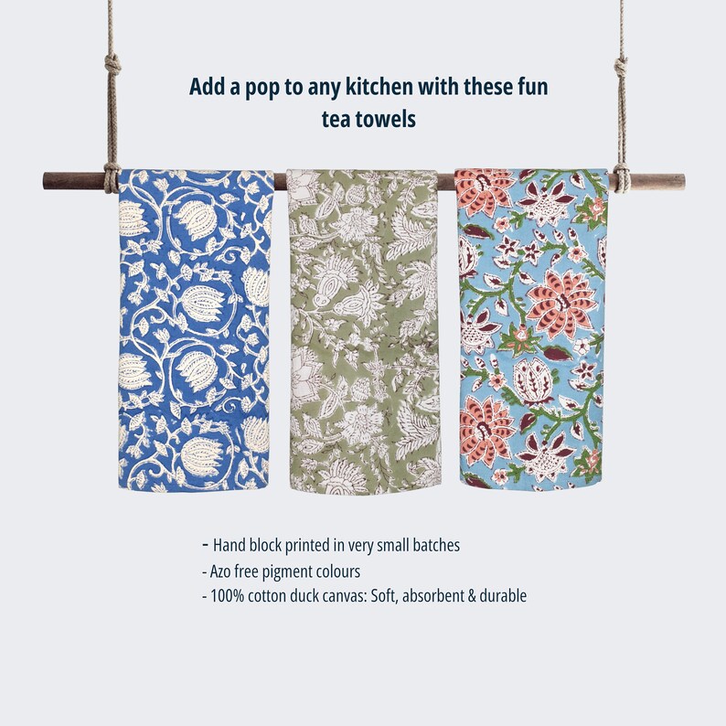 May include: Three hand-printed tea towels hanging on a wooden rod. The towels feature floral patterns in blue, green, and orange on a white background. The text on the image reads: "Add a pop to any kitchen with these fun tea towels - Hand block printed in very small batches - Azo free pigment colours - 100% cotton duck canvas: Soft, absorbent & durable"