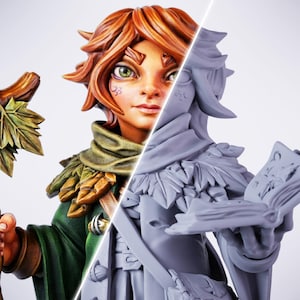 以下が含まれることがあります： ファンタジーフィギュアの分割画像。左側は、赤毛、緑の目、緑と茶色の衣装の塗装済みのフィギュアです。右側は、同じフィギュアのグレーの未塗装3Dプリントです。