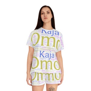 Könnte beinhalten: Weißer Pyjama mit einem kurzärmeligen Oberteil und Shorts. Der Pyjama hat einen Druck mit koreanischen Wörtern in verschiedenen Schattierungen von Lila, Blau und Gelb.