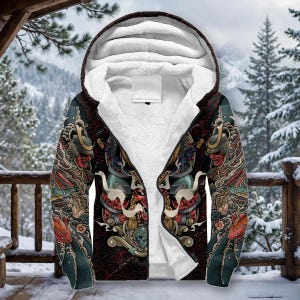May include: A zip-up hoodie featuring a white sherpa fleece lining and a dark exterior with a detailed graphic print of a samurai helmet, koi fish, and swirling patterns. The garment includes a hood, long sleeves, and a front zipper closure.