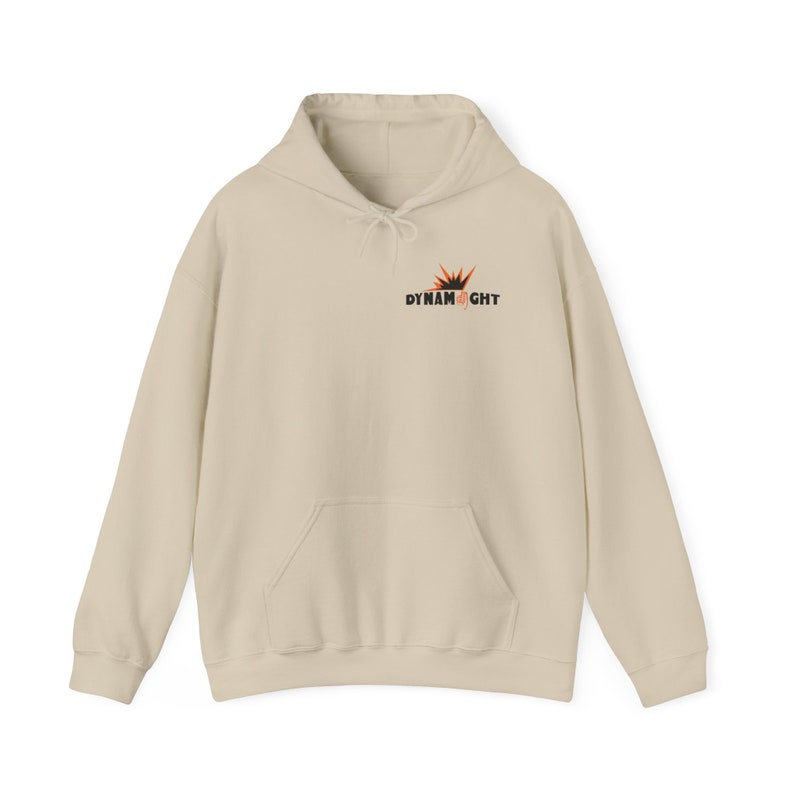 May include: A beige hoodie with a kangaroo pocket and a drawstring hood. The hoodie has a black and orange graphic on the front that says "Dynamight".