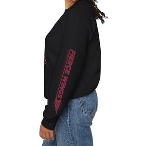 May include: Black sweatshirt with long sleeves and a red graphic on the left sleeve that says "Fierce Wings" in a white outline.