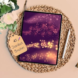 May include: A tablet screen displaying a purple background with 43 different stardust brushes. The brushes are in the shape of stars and are arranged in a variety of patterns. The text "43 Stardust Brushes" is displayed on a brown tag.