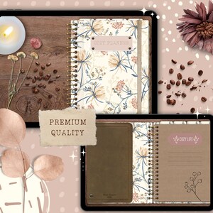 May include: A digital planner with a floral design and a brown leather cover. The planner has a spiral binding and a tab that says "Cozy Life". The planner is on a tablet screen with a wooden background.
