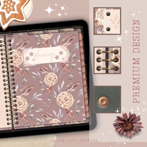 May include: A pink floral planner with a gold spiral binding and the word "planning" written on a white label. The planner is open to a page with a floral pattern. The image also includes a close-up of the binding, a decorative flower, and a small leather-bound notebook.